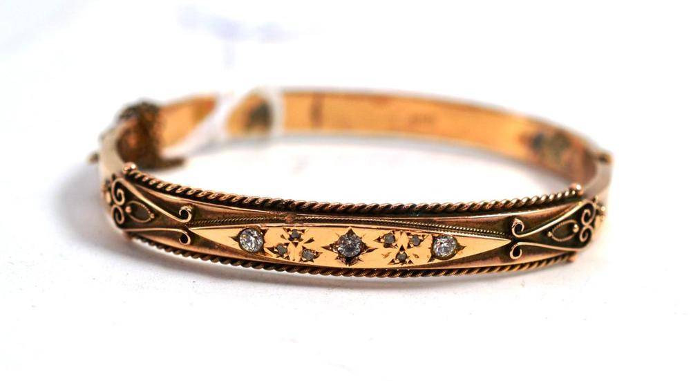 Lot 54 - A 9ct bangle with stones, some repair