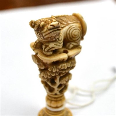 Lot 143 - A Chinese Ivory Seal, 19th century, as a dog of fo on a stem of flowering trees and branches,...