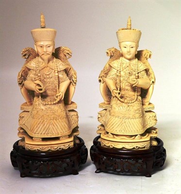 Lot 144 - A Pair of Chinese Ivory Figures of Seated Deities, late 19th century, he holding a ruyi sceptre and