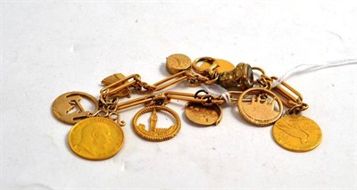 Lot 152 - A figaro link bracelet hung with ten charms, including a (soldered) 1908 half sovereign