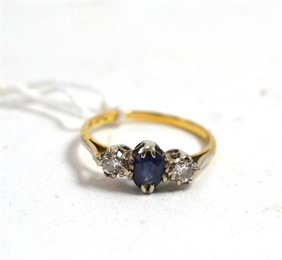 Lot 159 - An 18ct gold diamond and sapphire three stone ring