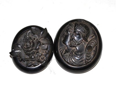 Lot 181 - Two carved jet brooches
