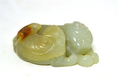 Lot 154 - A Chinese Jade Recumbent Fo Dog and Pup, Qing Dynasty, the stone of a pale green colour with russet