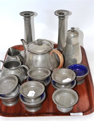 Lot 211 - A Liberty pewter caster, a three piece tea set, a pair of pewter candlesticks and ten pewter salts