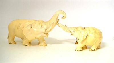 Lot 156 - An Indian Carved Ivory Elephant, late 19th century, stepping forward with raised trunk, with golden