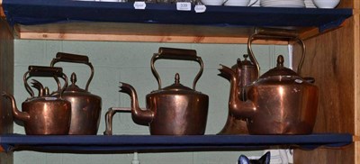 Lot 248 - A set of three graduated copper kettles with acorn finials, a kettle and trivet and a chocolate pot