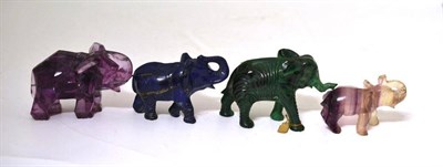 Lot 164 - Four Carved Stone Elephants, early 20th century, comprising  "cubist " purple spar example, and...