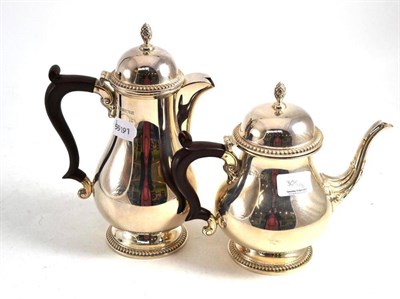 Lot 305 - A modern silver teapot and hot water jug