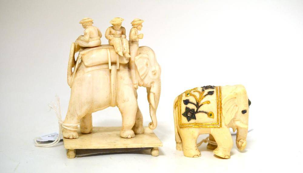 Lot 167 - An Indian Carved Elephant Ivory Figure of a Standing Elephant, circa 1863, with three men upon...