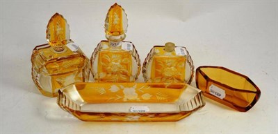 Lot 345 - A five piece amber flash glass dressing table set and another