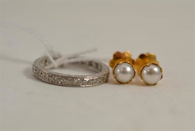 Lot 402 - A diamond full eternity ring and a pair of pearl stud earrings with screw-on fittings