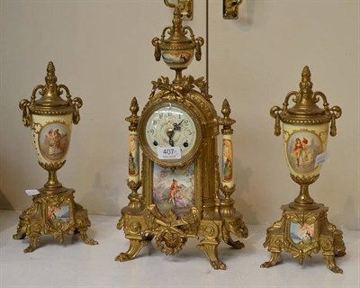 Lot 407 - A reproduction gilt metal striking mantel clock garniture