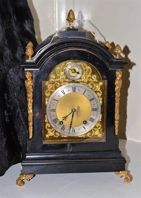 Lot 409 - An ebonised quarter striking mantel clock, movement stamped 'W&H'