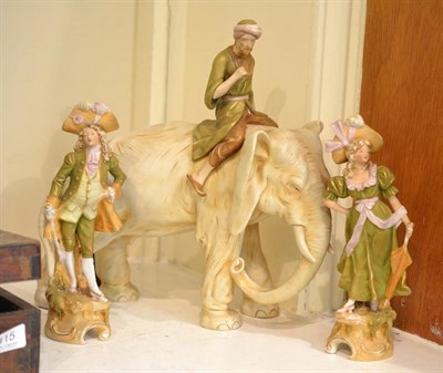 Lot 414 - A pair of Royal Dux figures and a model of a man on an elephant