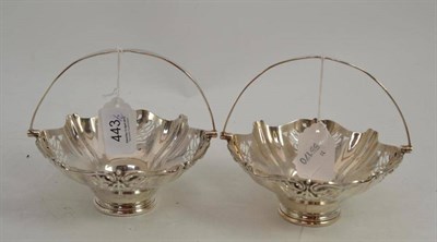 Lot 443 - A pair of pierced silver bonbon dishes with swing handles