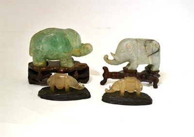 Lot 177 - A Pair of Chinese Carved Chalcedony Standing Elephants, late Qing Dynasty, the stylised and...