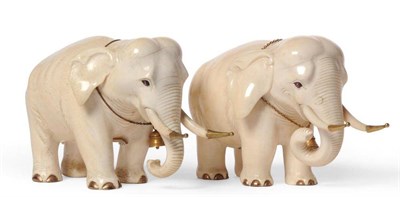 Lot 178 - A Pair of Indian Carved Ivory Standing Elephants, late 19th century, each with golden metal...