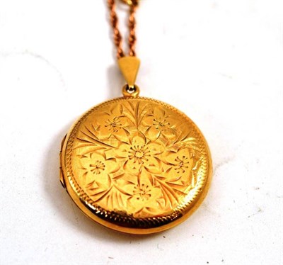 Lot 488 - A 9ct gold round locket on a fancy link chain