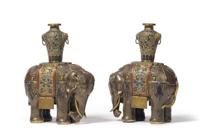 Lot 180 - A Pair of Chinese Cloisonné Enamel Elephants, Qing Dynasty, circa 1800, each standing beast...