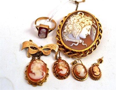 Lot 503 - A bow brooch with cameo drop, a cameo brooch, a cameo ring stamped '9CT', a cameo pendant and...