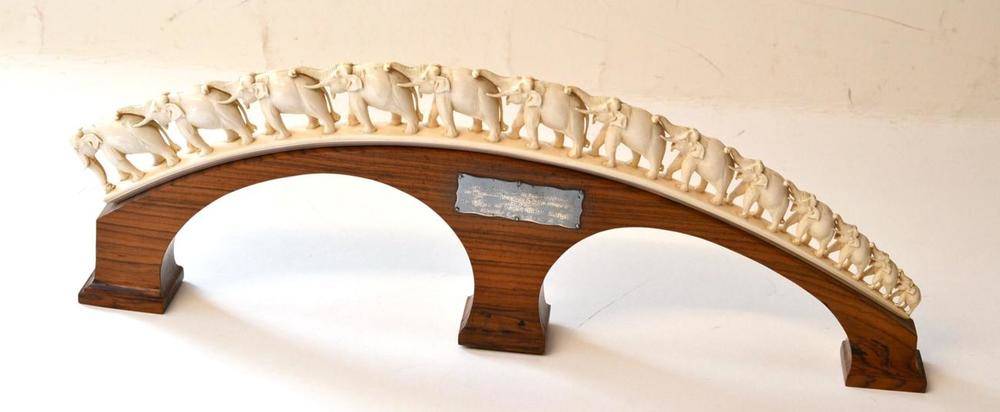 Lot 181 - An Indian Carved Elephant Ivory Bridge of Thirteen Elephants, circa 1958, upon a two-arched...