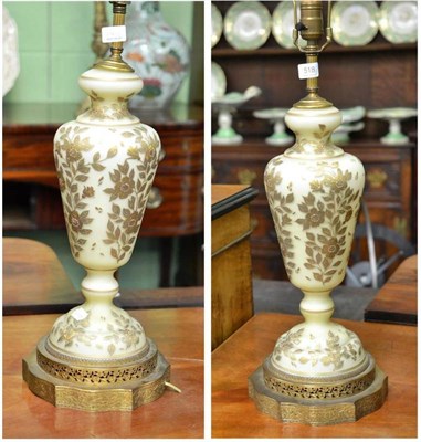 Lot 518 - A pair of frosted glass baluster vases with gilt floral highlights and chased metal mounts, mounted