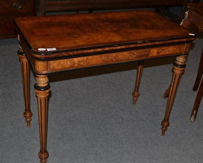 Lot 562 - A Victorian burr walnut fold-over card table with quartered top and marquetry inlay, 91cm wide