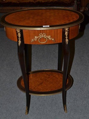 Lot 563 - A French style parquetry oval occasional table with gild metal mounts, 58cm wide