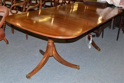 Lot 570 - A Regency style mahogany pedestal dining table with extra leaf, 212cm long