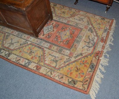 Lot 597 - Melas rug, West Anatolia, the faded terracotta field with five diamond medallions framed by...