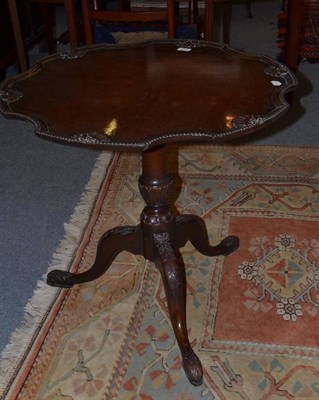 Lot 613 - A 19th century mahogany tilt top table, a hexagonal top with carved shell motif and border on a...