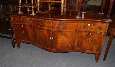 Lot 620 - A Regency serpentine fronted sideboard with an arrangement of three drawers over three...