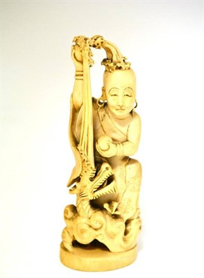Lot 193 - A Japanese One Piece Carved Elephant Ivory Figure of a Lohan, late Meiji period, the bald sage...