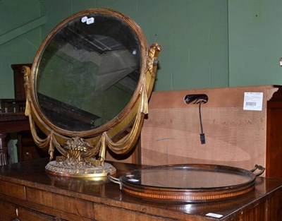 Lot 648 - A reproduction giltwood oval mirror, 86cm wide and an inlaid mahogany tray