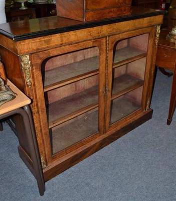 Lot 667 - A Victorian walnut enclosed bookcase with boxwood stringing and gilt metal mounts, 122cm wide