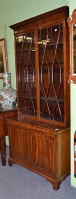 Lot 673 - A reproduction mahogany bookcase with astragal glazed top and cupboard base, 224cm high