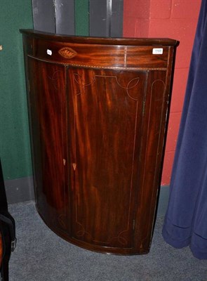 Lot 1169 - George III mahogany bow front corner cabinet