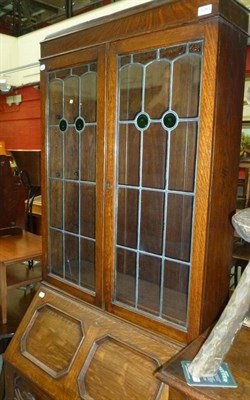 Lot 1280 - An oak bureau bookcase and a pair of rustic chairs