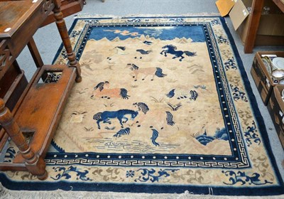 Lot 1295 - Large Chinese rug, the cream field with horses in a mountainous landscape enclosed by floral...