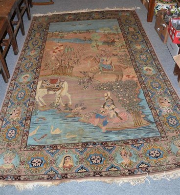 Lot 1317 - A Kashmir pictorial rug North West India, the field depicting a rural scene enclosed by...