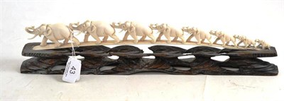 Lot 43 - Carved ivory elephants on wood stand
