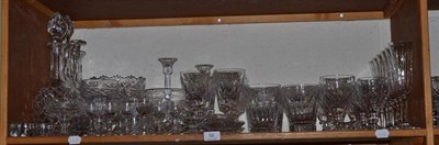 Lot 56 - A collection of cut crystal and glass drinking glasses, decanters etc (on two shelves)