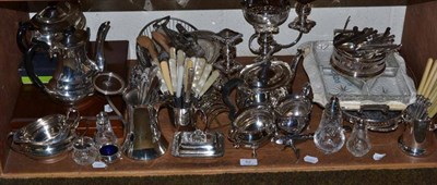 Lot 62 - A shelf of silver plated items including two tea sets, flatware, candelabrum, hors d'oeuvres...