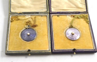 Lot 74 - Two purple enamelled lockets on chains, in fitted cases by D & J Wellby, Garrick St., London,...