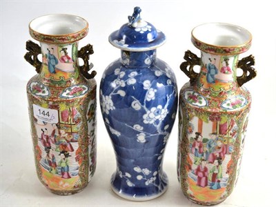 Lot 144 - A pair of Canton famille rose vases (a.f.) and a Chinese blue and white vase and cover (a.f.)