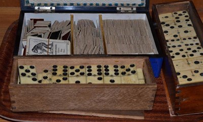 Lot 154 - Two sets of bone and ebony dominoes (cased) and a blue and gilt box 'Cards' containing a...