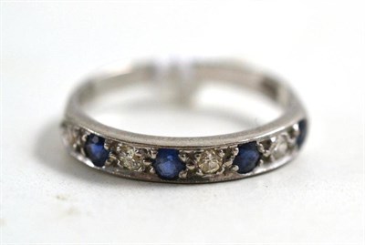Lot 181 - A sapphire and diamond half hoop ring, stamped '18CT'