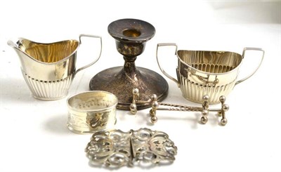 Lot 183 - A nurses buckle, napkin ring, pair of knife rests, dwarf candlesticks, cream and sugar