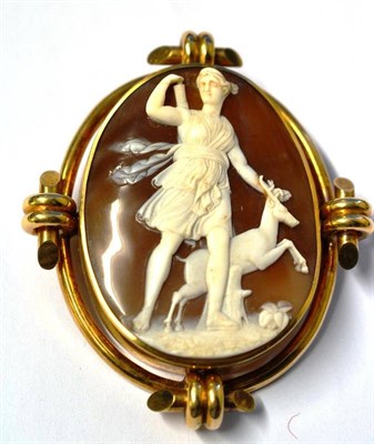 Lot 251 - A Cameo Brooch, the oval shell cameo carved to depict Diana the Huntress, within a tubular...