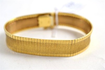 Lot 256 - A textured finish bracelet, stamped '750'